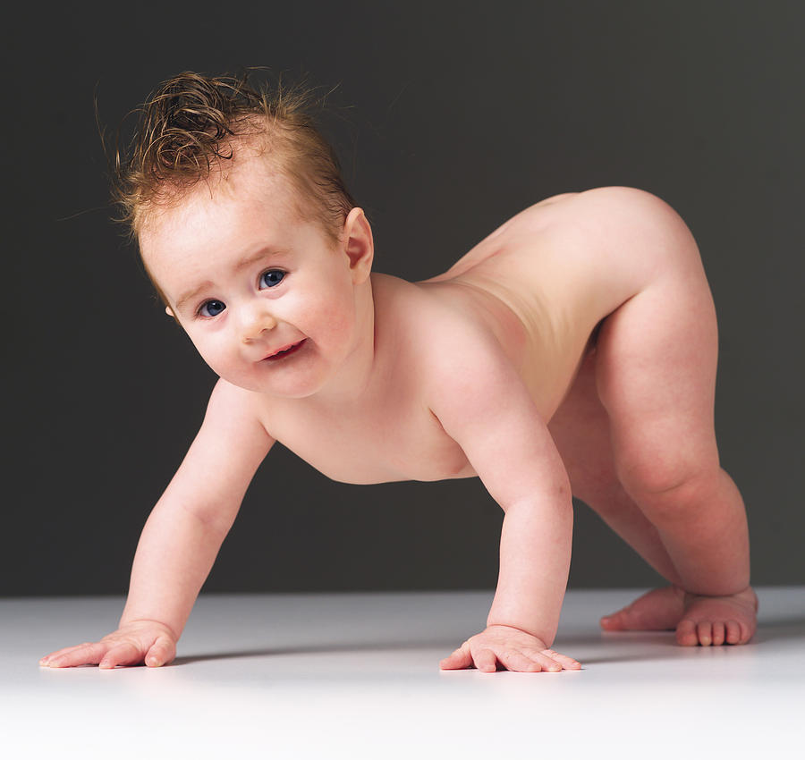 A Naked Caucasain Baby Holds Itself Up On Its Arms Photograph by Photodisc