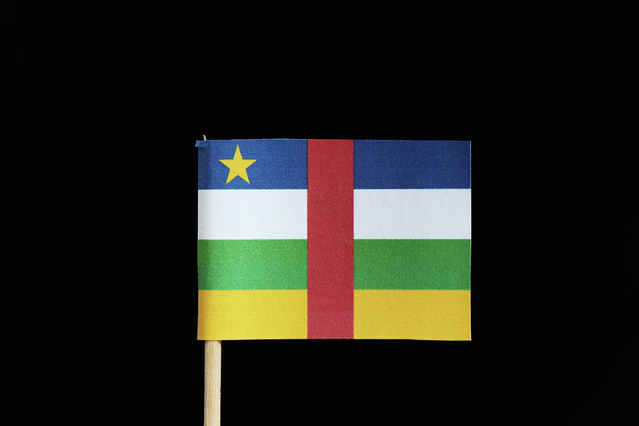 A original and official flag of Central African Republic on toothpick on black background. Flag is created five colours blue, red, white, green and yellow and one white stars Photograph by Vaclav Sonnek