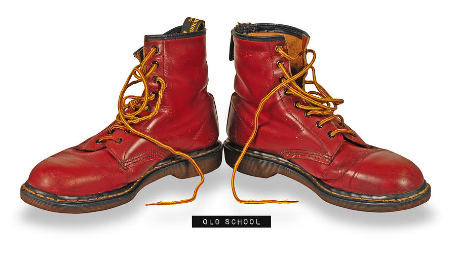 A pair of classic cherry Dr. Martens boots, with distinctive yellow stitching around the sole. Digital by Drinkall - Pixels