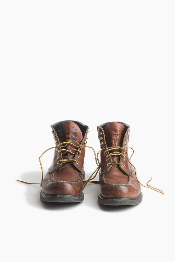 A pair of worn work boots Photograph by Andreas Schlegel
