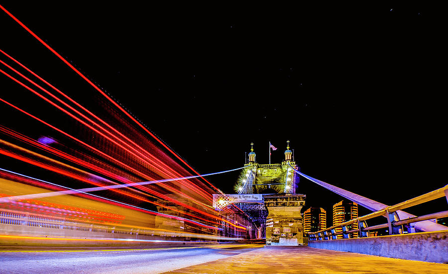 A Party Bus Crosses the Roebling Bridge Cincinnati Ohio Photograph by Dave Morgan