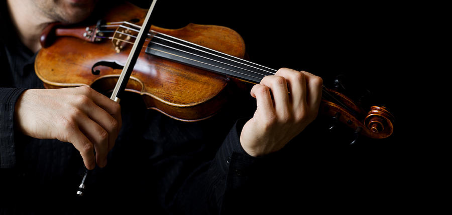 A person playing the violin showing hands holding the bow Photograph by EmirMemedovski