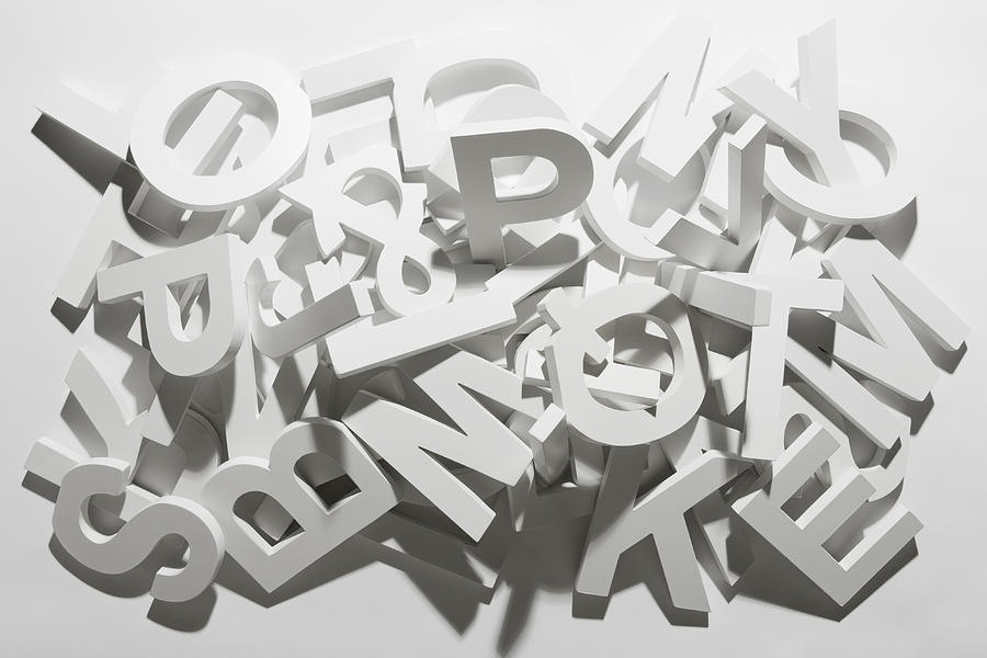 A pile of various white block letters from the alphabet Photograph by Caspar Benson