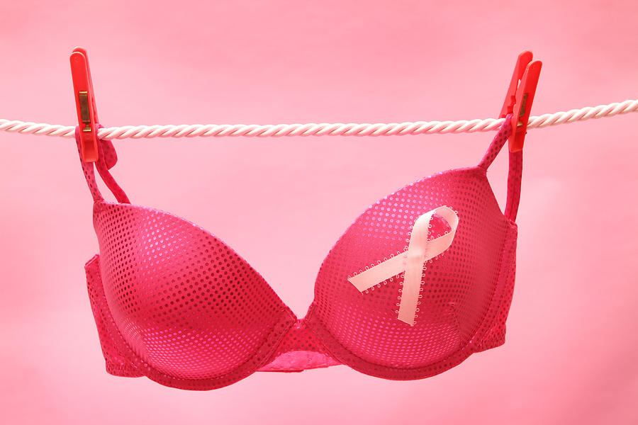 A pink bra hanging on a rope for Breast Cancer Awareness Photograph by Hidesy