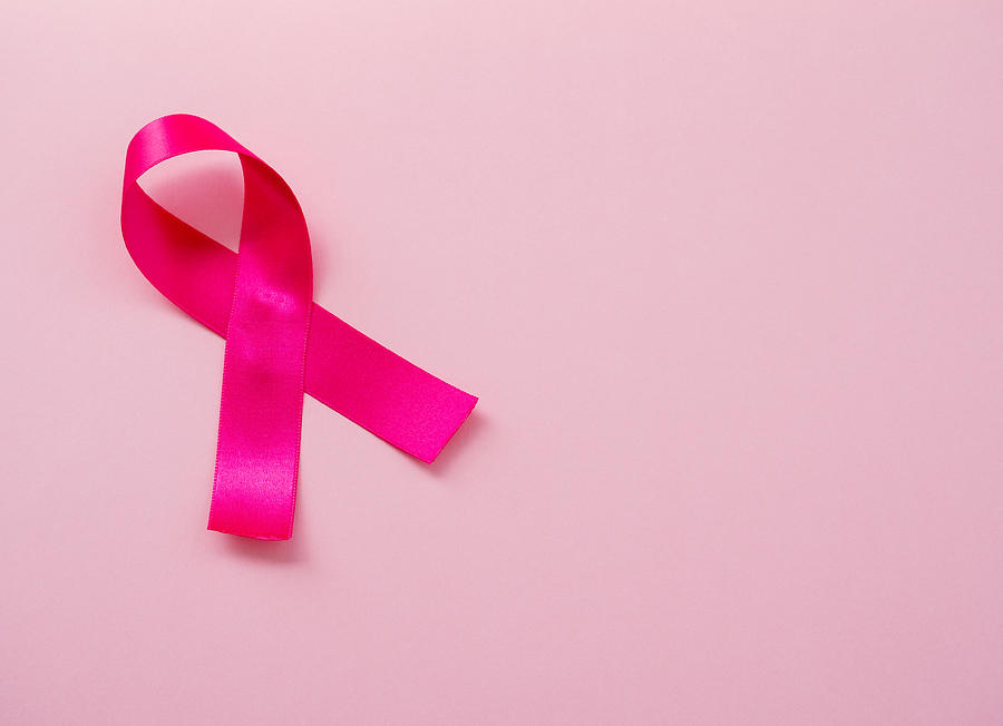A pink ribbon on a pastel pink background. Breast cancer concept Photograph by Ana Maria Serrano