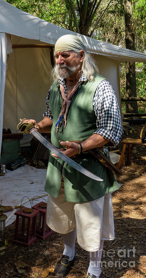 A pirate reenactor shows his cutlass at the Old Florida Festival Photograph by William Kuta