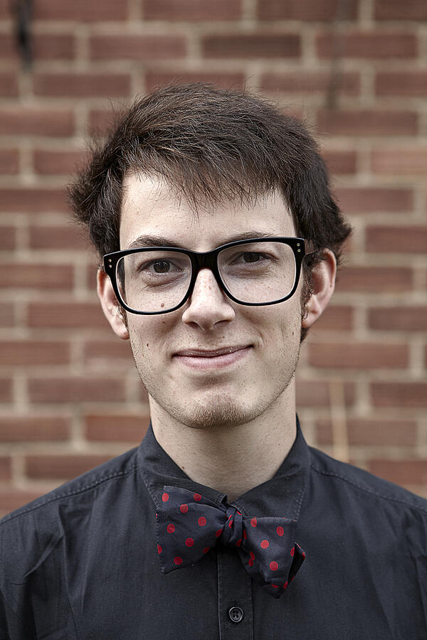 A portrait of a young male wearing glasses. Photograph by Jamie Garbutt