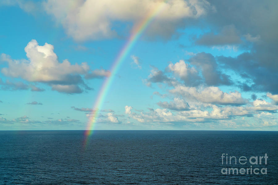A rainbow appears over the Caribbean near the island of Saint Ma Photograph by William Kuta