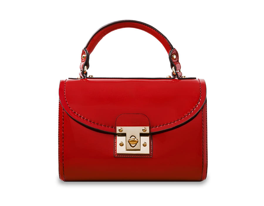 A red handbag on a white background. Photograph by Richard Boll