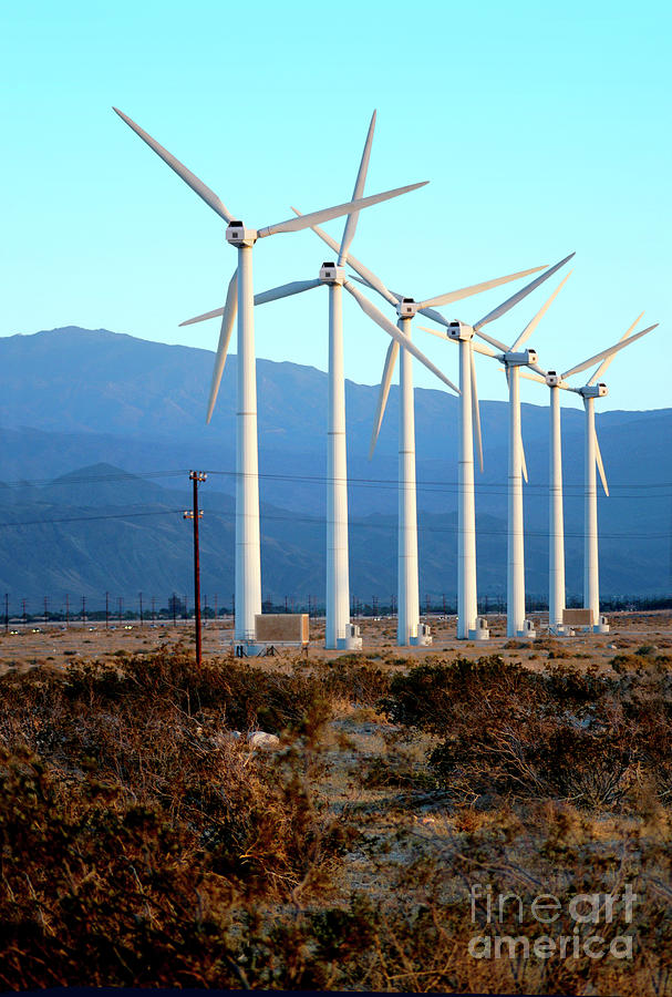 A row of wind turbines to produce green energy in the Palm Springs area of California.	 Photograph by Gunther Allen