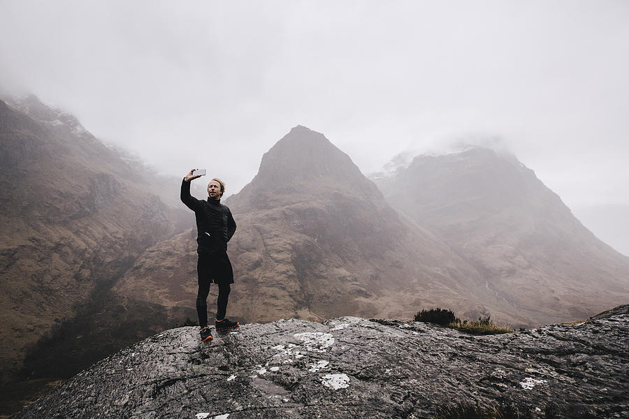A runner takes a selfie on a mountain in Scotland Photograph by Luca Sage