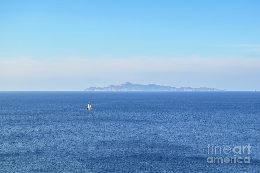 A sailboat on the Mediterranean Sea, as viewed from Cape Sounion Photograph by William Kuta