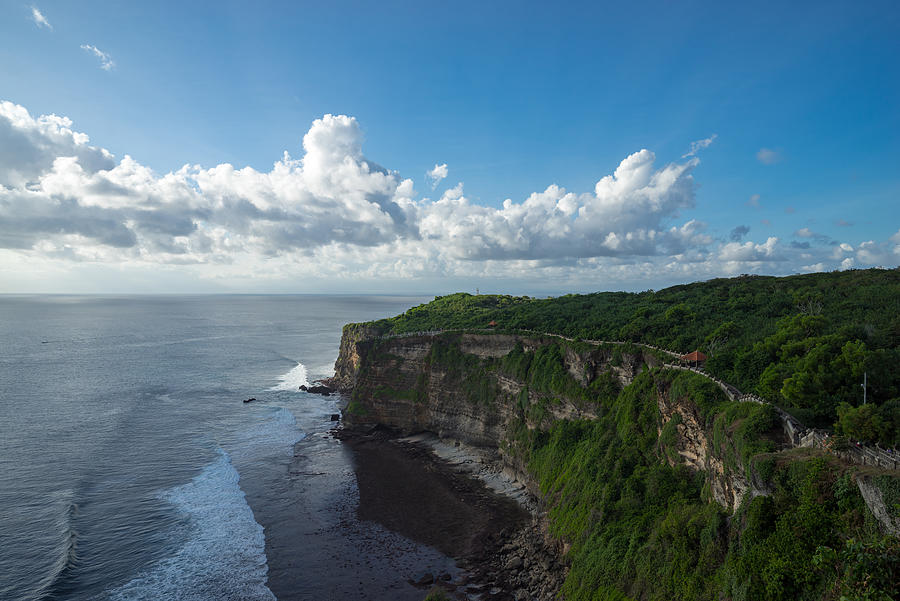 A scenic Uluwatu cliff with pavilion and blue sea in Bali, Indonesia. Photograph by Shaifulzamri