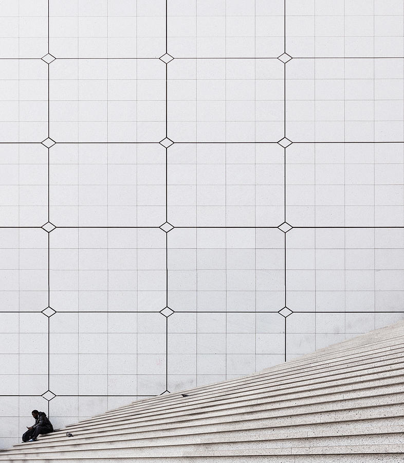 A seating man taking a relaxation break at the staircase of the Grande Arche at La Défense, Paris Photograph by Christian Beirle González