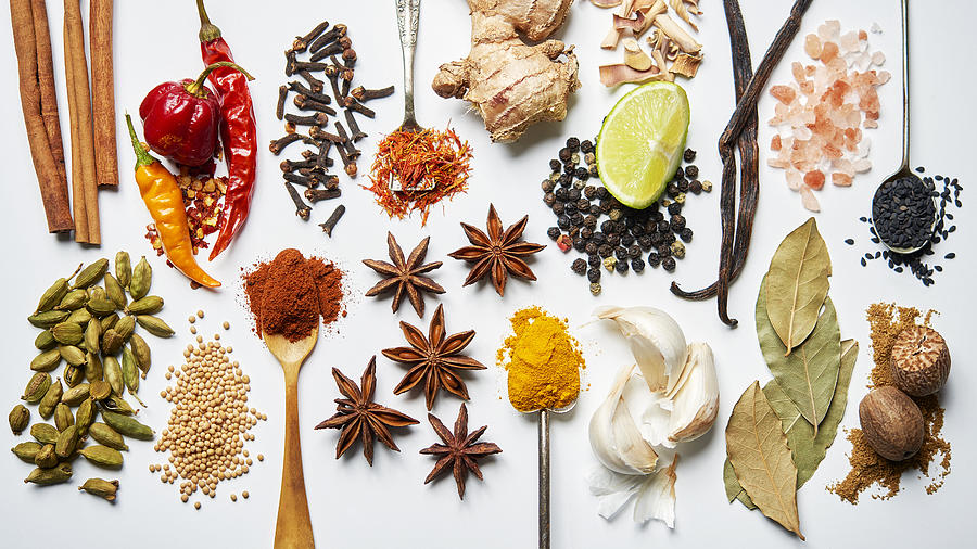 A selection of spices on a white background Photograph by David Malan