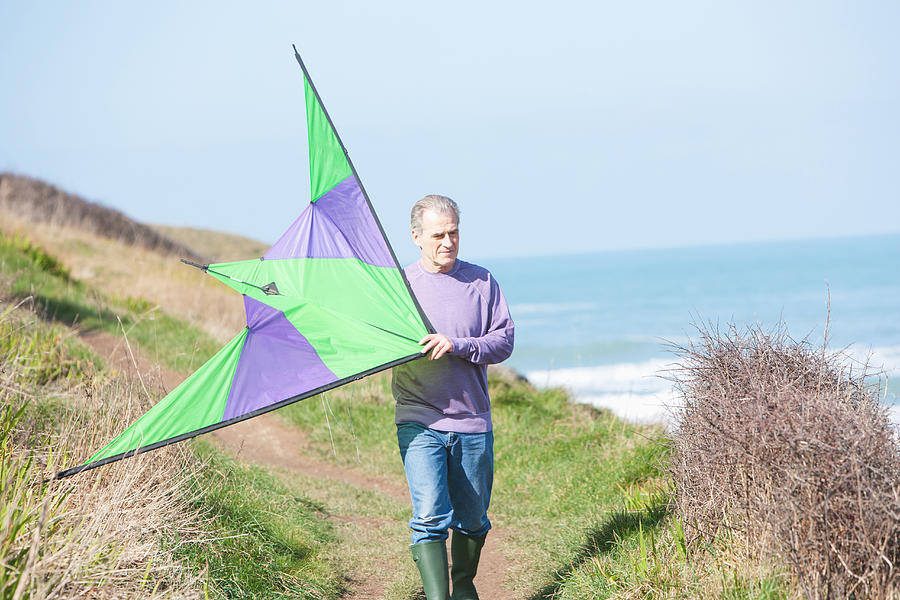 A Senior Man With A Kite At The Beach Photograph by Tom Merton