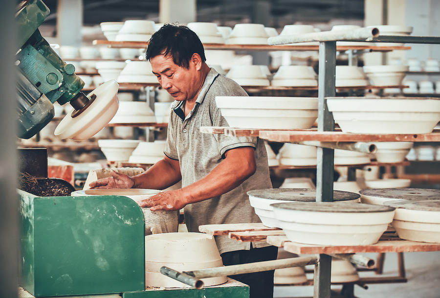 A Senior Staff Polishing Porcelain Clay in Factory Photograph by Chalffy