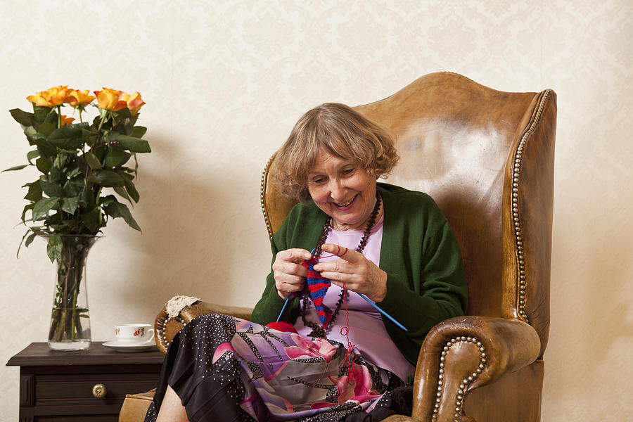A senior woman enjoying knitting Photograph by Caspar Benson