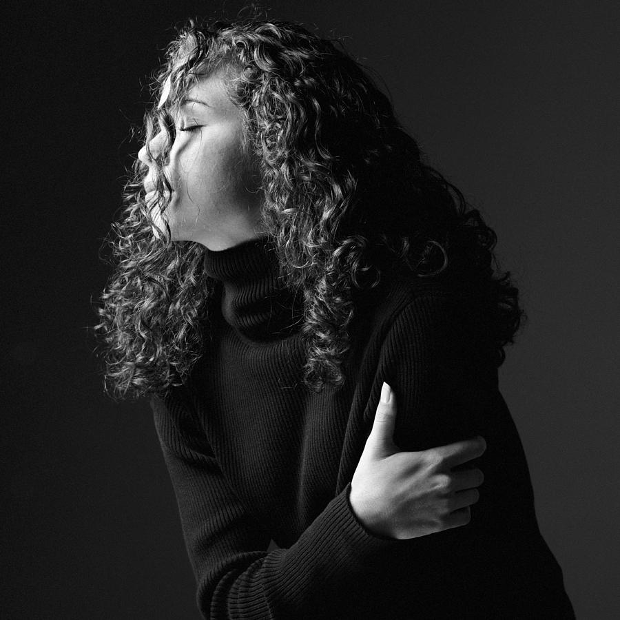 A Side Profile Of A Young Caucasian Woman Whose Face Is Obscured My Her Long Curly Hair Photograph by Photodisc