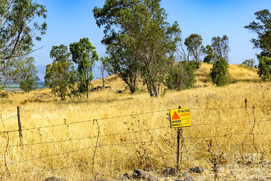 A sign warns of uncleared mines in the Golan Heights, Israel. A Syrian  bunker from the 6-Day War is in the background. Photograph by William Kuta  - Fine Art America