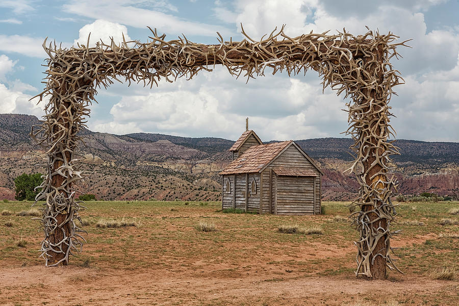 A Small Chapel Framed by Antlers Gate at Ghost Ranch Photograph by Belinda Greb