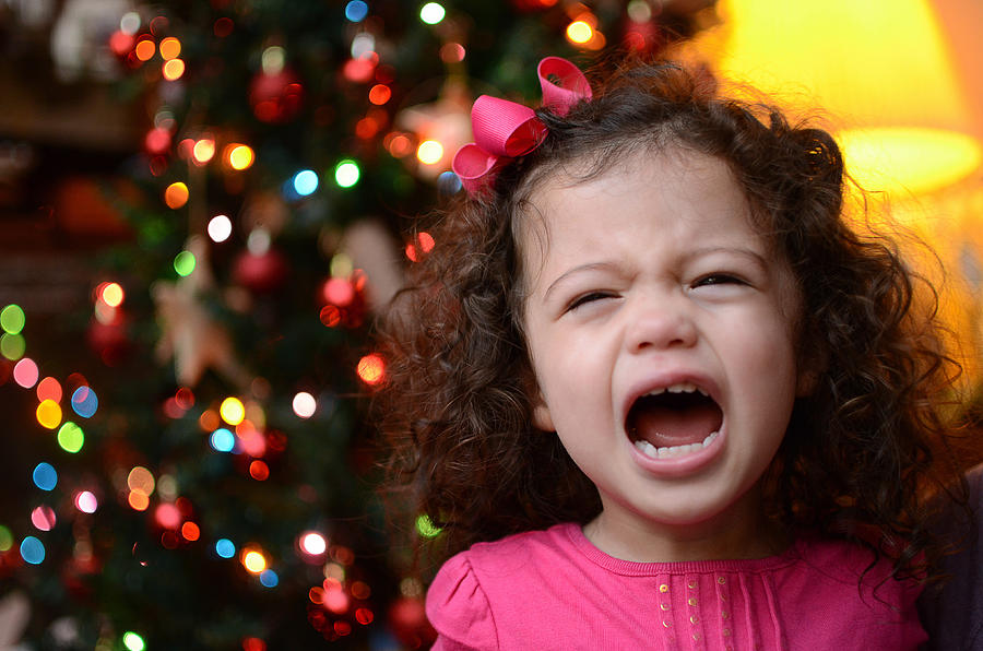A small child crying at Christmas Photograph by Kevin Reid
