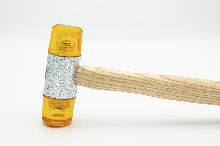 A small orange rubber mallet lying on a white background Photograph by  Stefan Rotter - Pixels