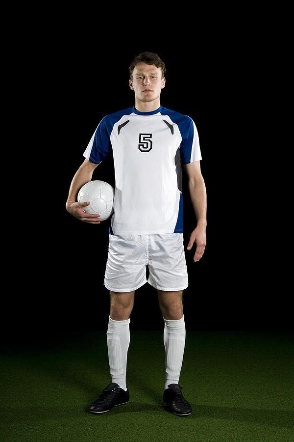 A soccer player, portrait, studio shot Photograph by Antenna