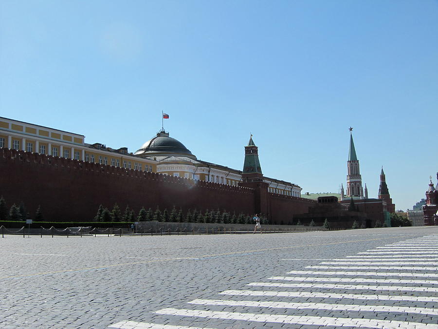 A Solitary Pedestrian in Red Square Photograph by Calvin Boyer
