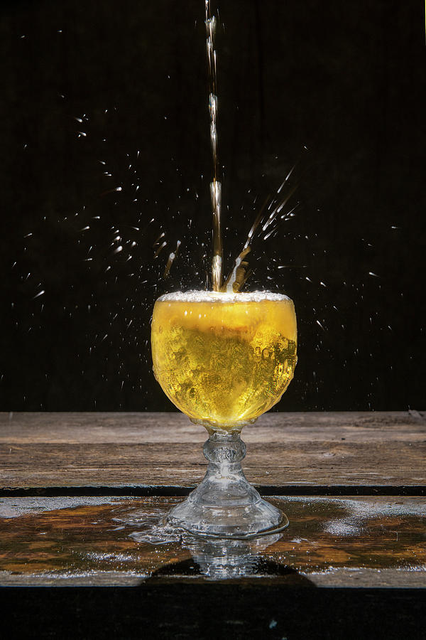 A splash of gold liquid Photograph by Dan Friend
