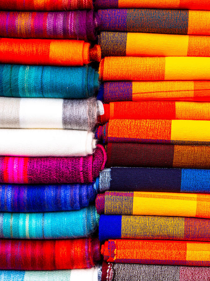 A Stack of blankets for sale at the Otavalo Market in Ecuador Photograph by L Bosco