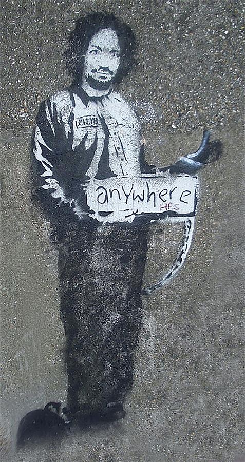 A stencil of Charles Manson in a prison suit, hitchhiking to anywhere ...