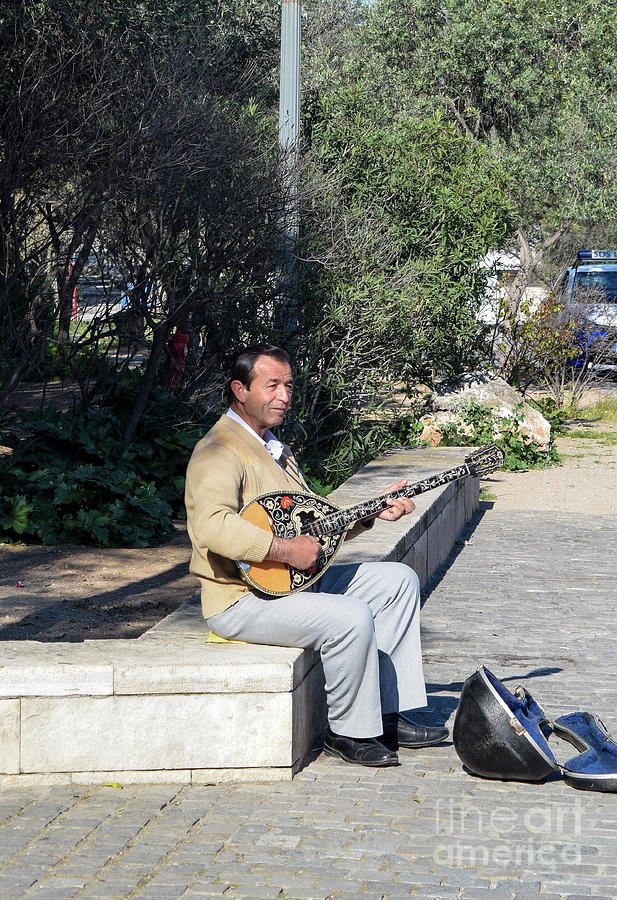 A street busker plays a bouzouki, in Athens, Greece Photograph by William Kuta