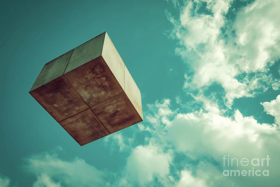 A surreal photograph capturing a square object seemingly defying gravity as it hovers effortlessly a Photograph by Joaquin Corbalan