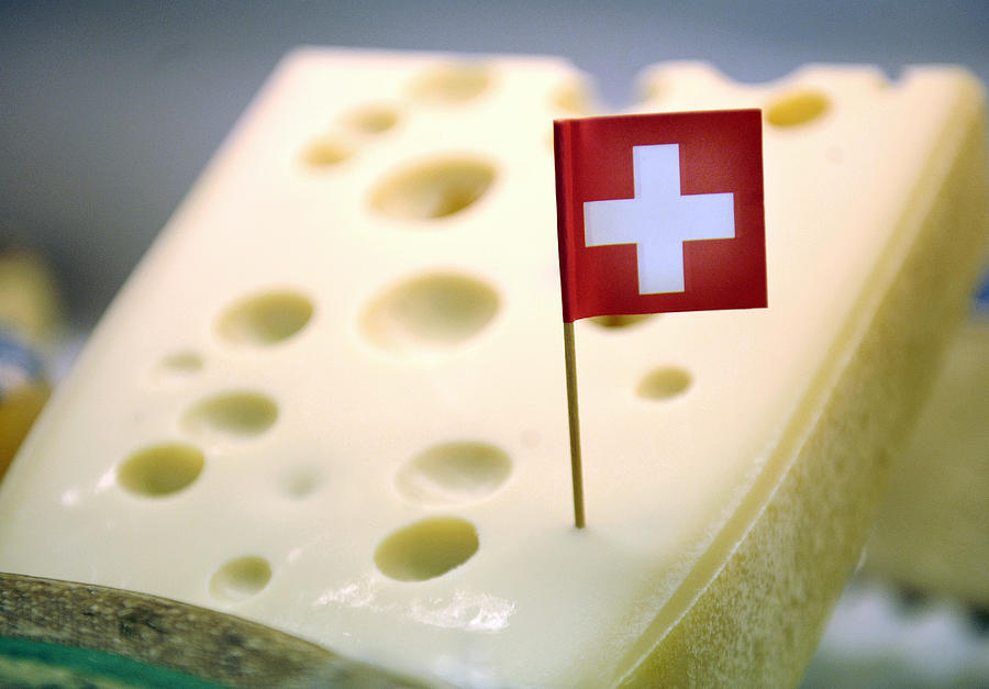 A Swiss flag is seen in a piece of Emmenthaler cheese Photograph by Bloomberg Creative Photos