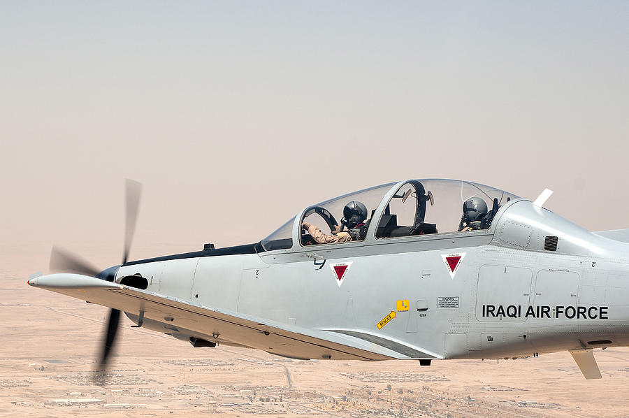 A T-6 Texan flying over Camp Speicher, Tikrit, Iraq. Photograph by Stocktrek Images
