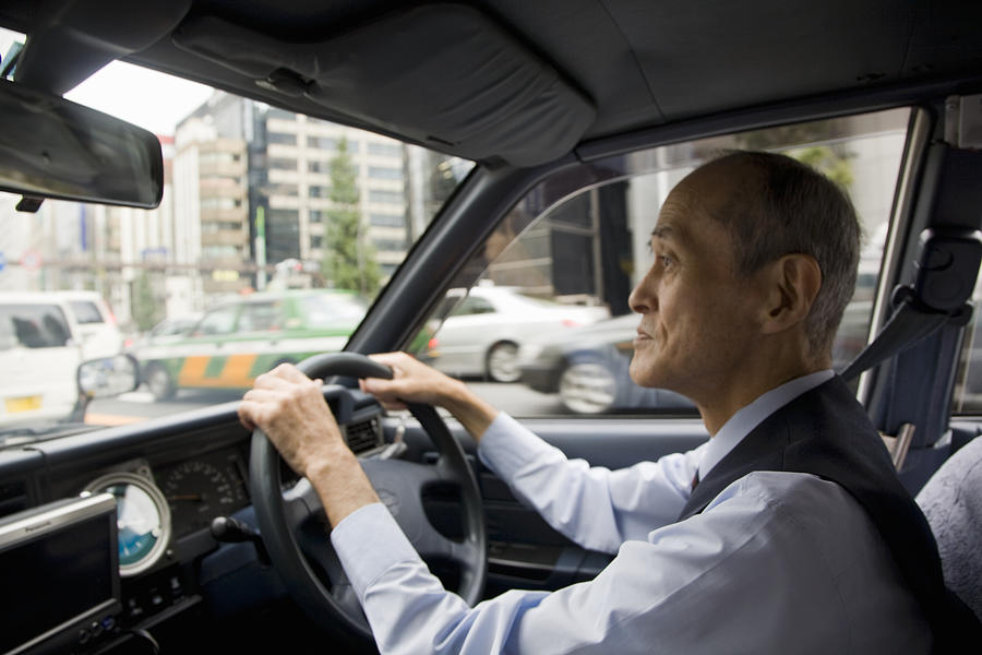 A taxi driver operating his vehicle Photograph by Jerry Driendl