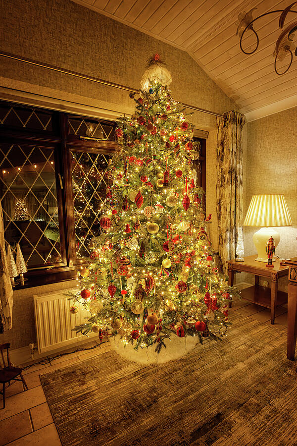 Holiday Photograph - A traditional English Christmas Tree decorated with thousands of twinkling lights and hundreds of co by John Gilham Holiday Photograph - A traditional English Christmas Tree decorated with thousands of twinkling lights and hundreds of co by John Gilham
