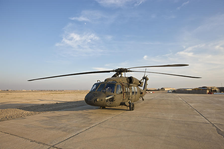 A UH-60 Black Hawk parked on the maintenance pad at a military base in Tikrit, Iraq. Photograph by Terry Moore/Stocktrek Images