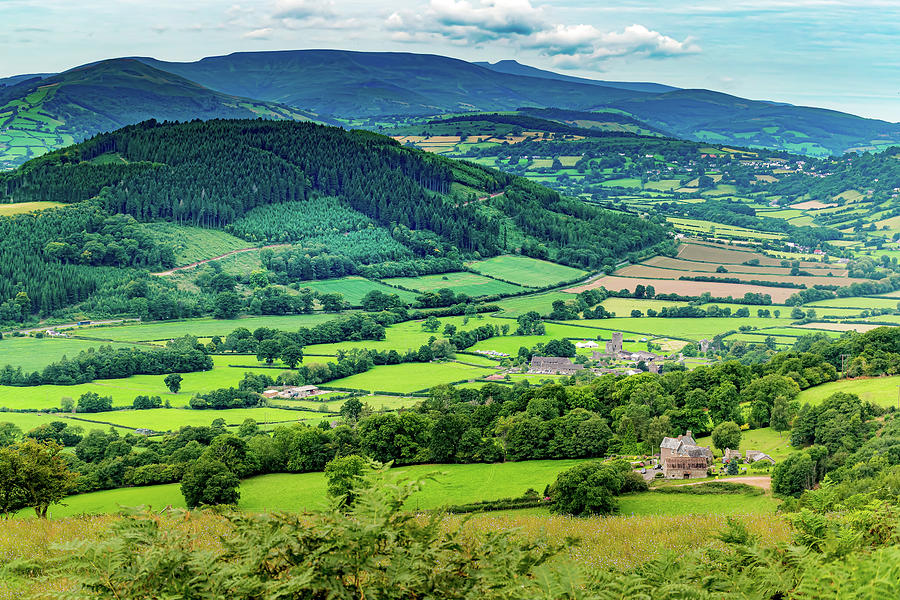 A valley in Powys with Tretower Castle and the Brecon Beacons ...