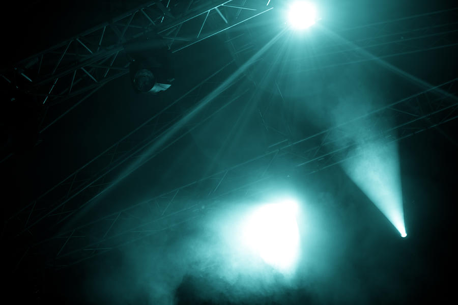 A view of foggy stage lights emerging from the dark Photograph by Troyek