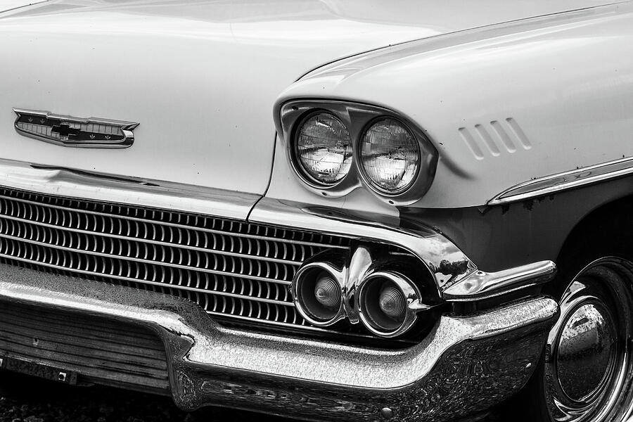 A Vintage Car With Chrome Trim And A Chrome Grille Photograph