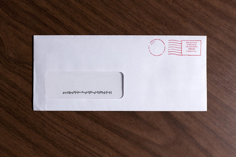 A window envelope with no address, but a barcode and red ink postage stamp Photograph by Epoxydude