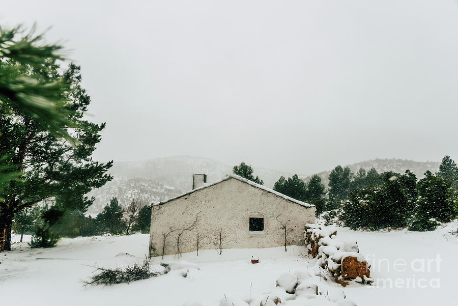 A winter day with snow on a rural house. Photograph by Joaquin Corbalan