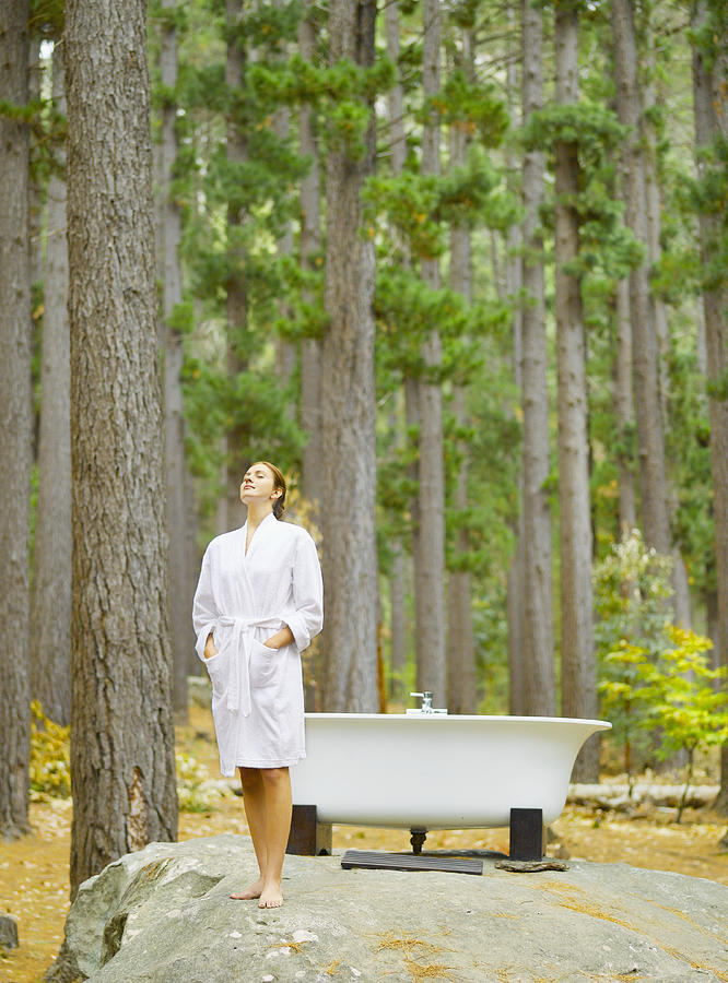 A woman before bathing outdoors in the woods Photograph by OJO Images