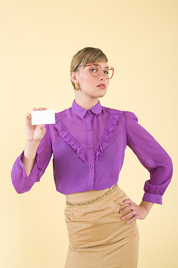 A woman holding a business card Photograph by Image Source A woman holding a business card Photograph by Image Source