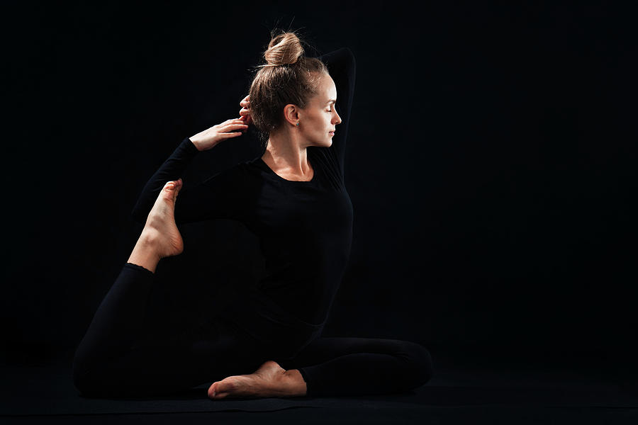 A Woman Is Practicing Yoga Photograph