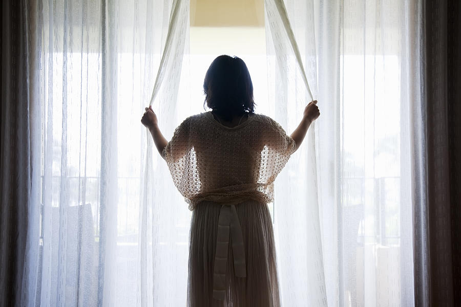 A Woman Opening Curtains Of Hotel Room Photograph by Kohei Hara