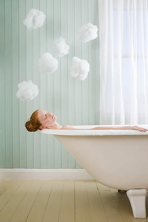 A woman relaxing in the bath Photograph by Image Source