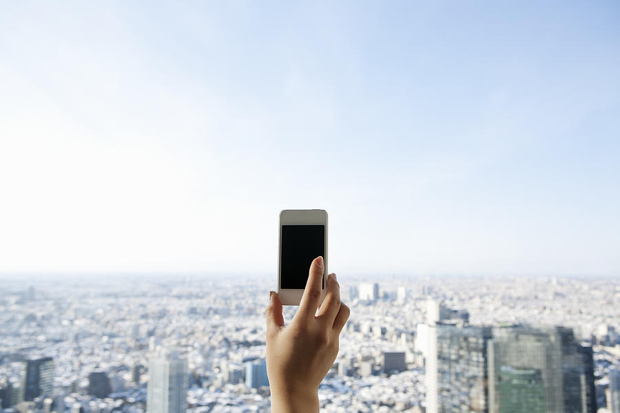 A Woman Using A Smart Phone In A Skyscraper Photograph by Kohei Hara